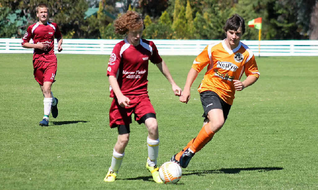 Warwick Wolves player Daniel King (front left) is pursued by City opponent Jacob Marsh in an early game this season.